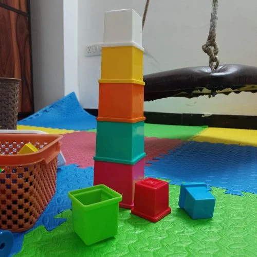 Stacking blocks on colourful floor mats